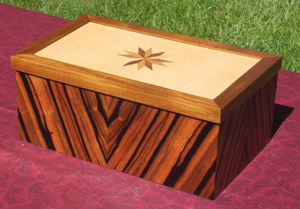 Custom inlaid box with Ebony body, Teak trim around lid, Boxwood Top Star Inlay consists of Cherry and Walnut